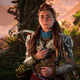 Aloy stands in front of a tree in Horizon Forbidden West.